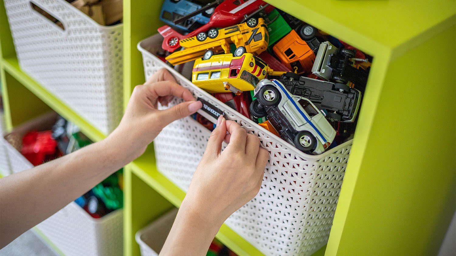 mother labeling toy bins