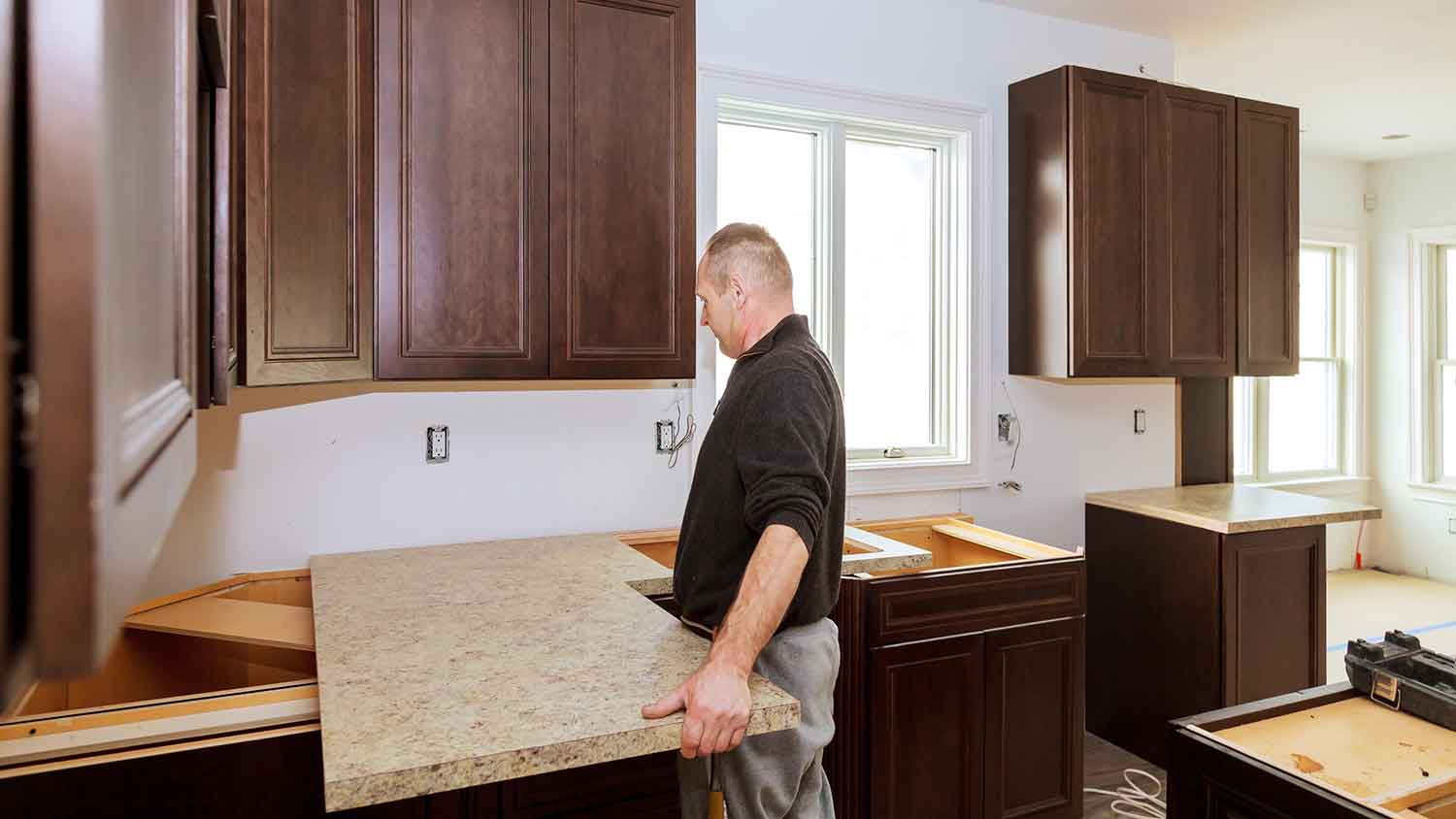 Contractor installing laminate kitchen countertop