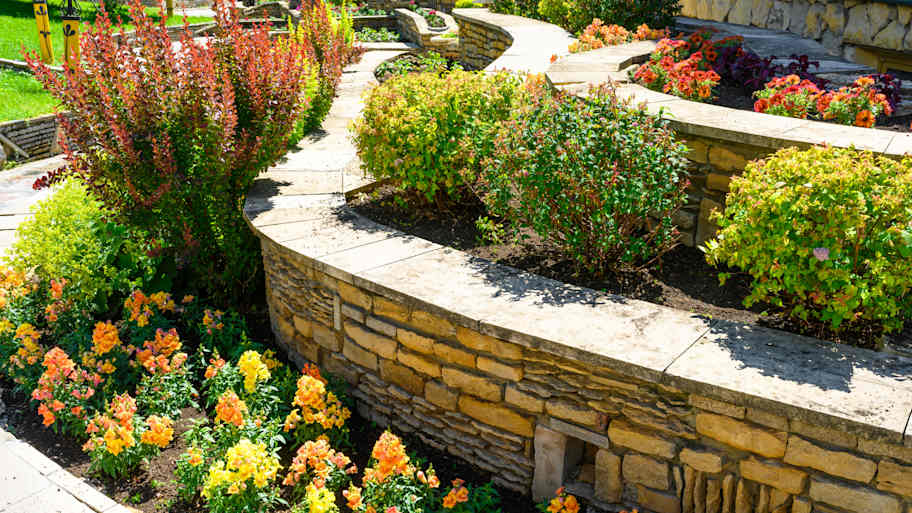 Landscaping with retaining walls and flowerbeds