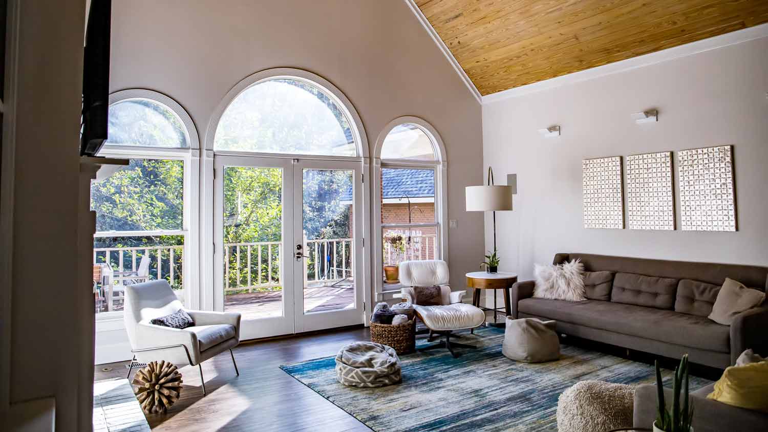 spacious living room with large arched window