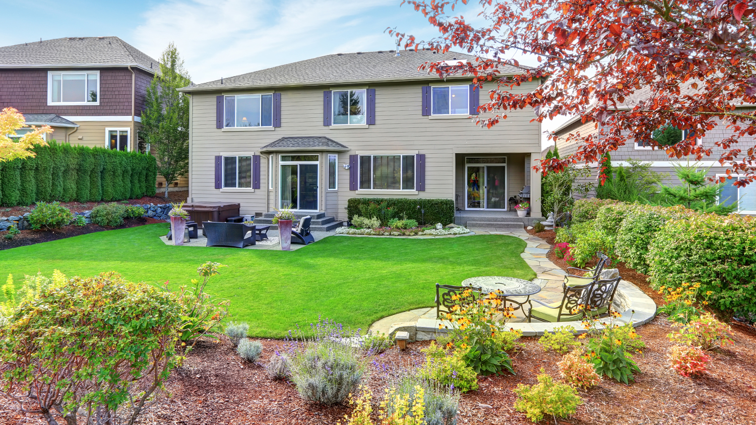 home with different plants in backyard landscape