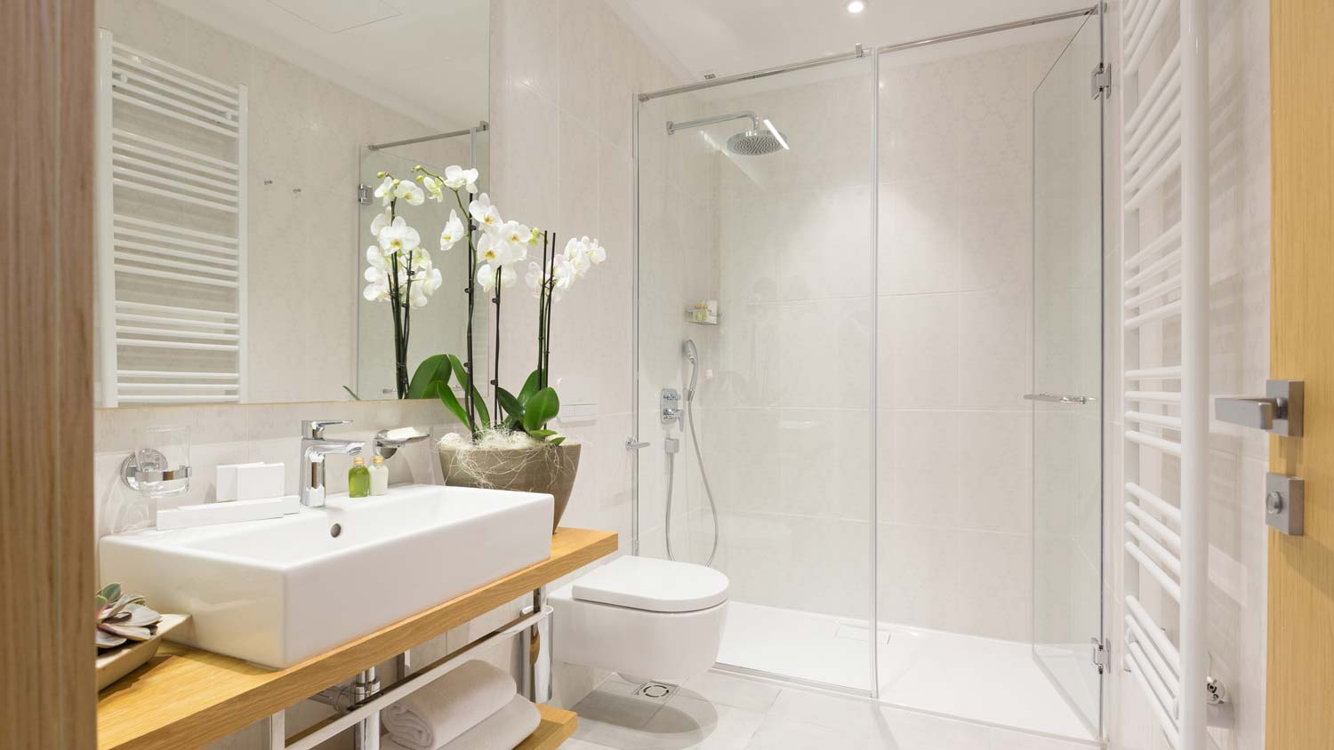 A large bathroom with a curbless shower pan