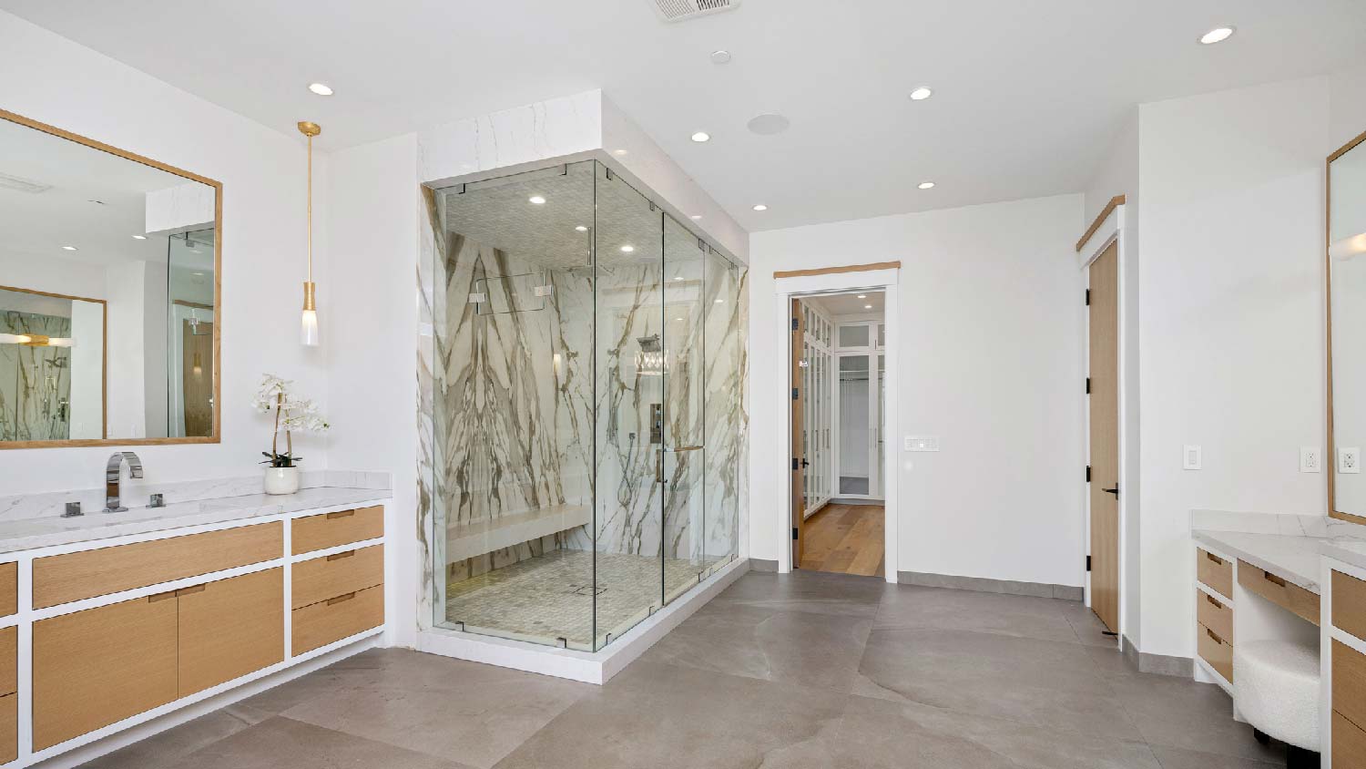A large bathroom with a shower and a vanity