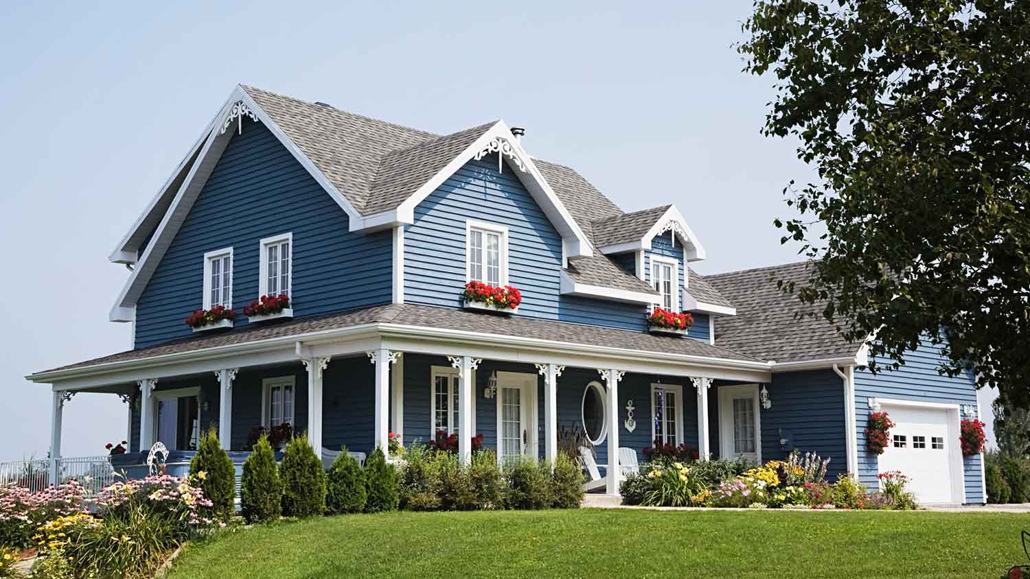 Large blue house exterior with flower boxes