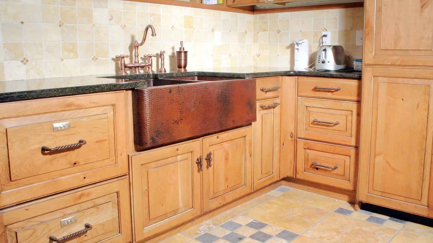 Large copper sink installed in a rustic style kitchen