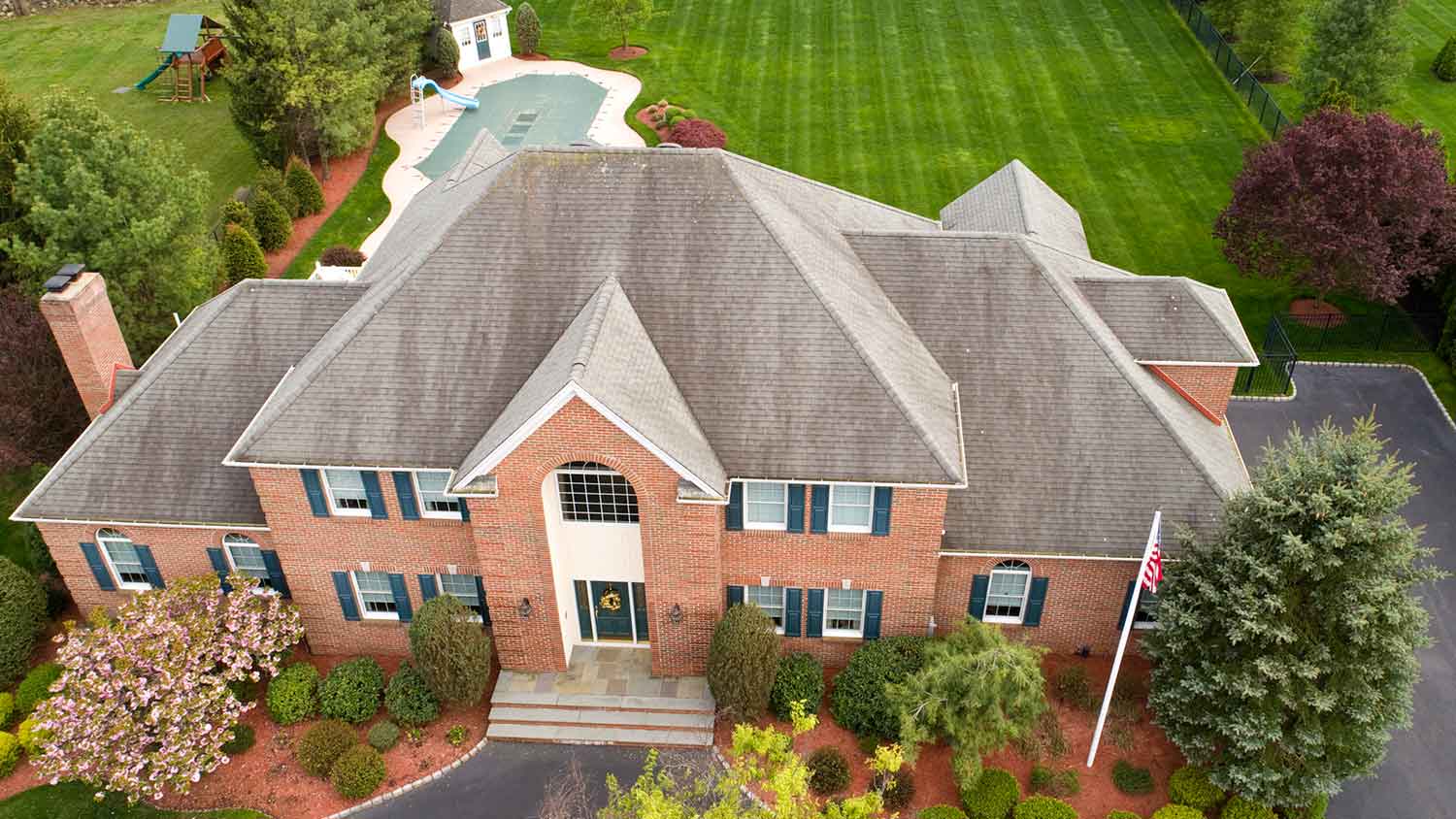 Aerial view of a large house with a hip roof