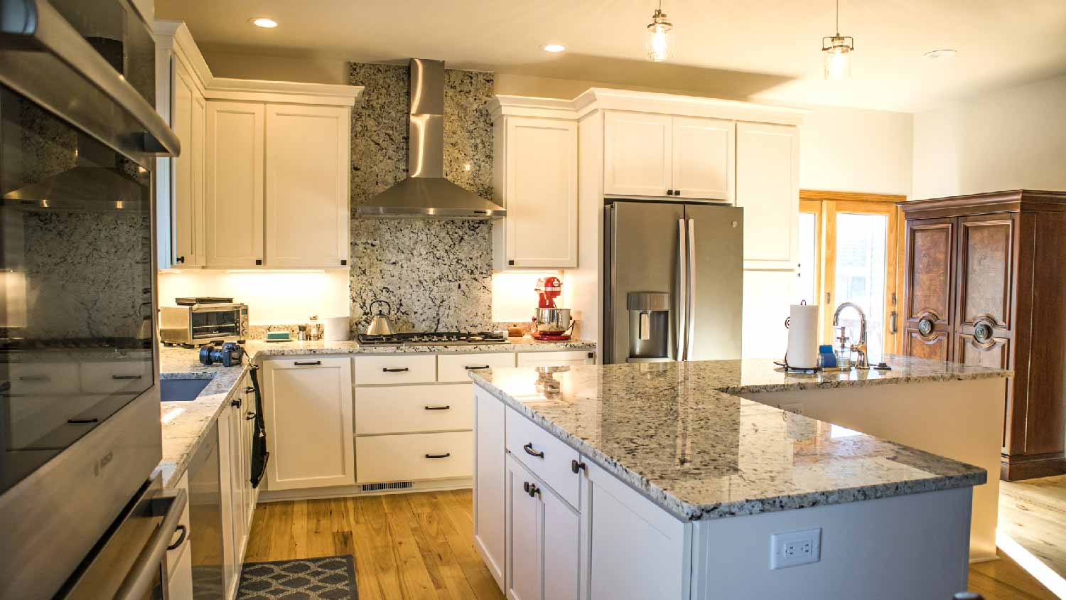 A large kitchen with granite countertops