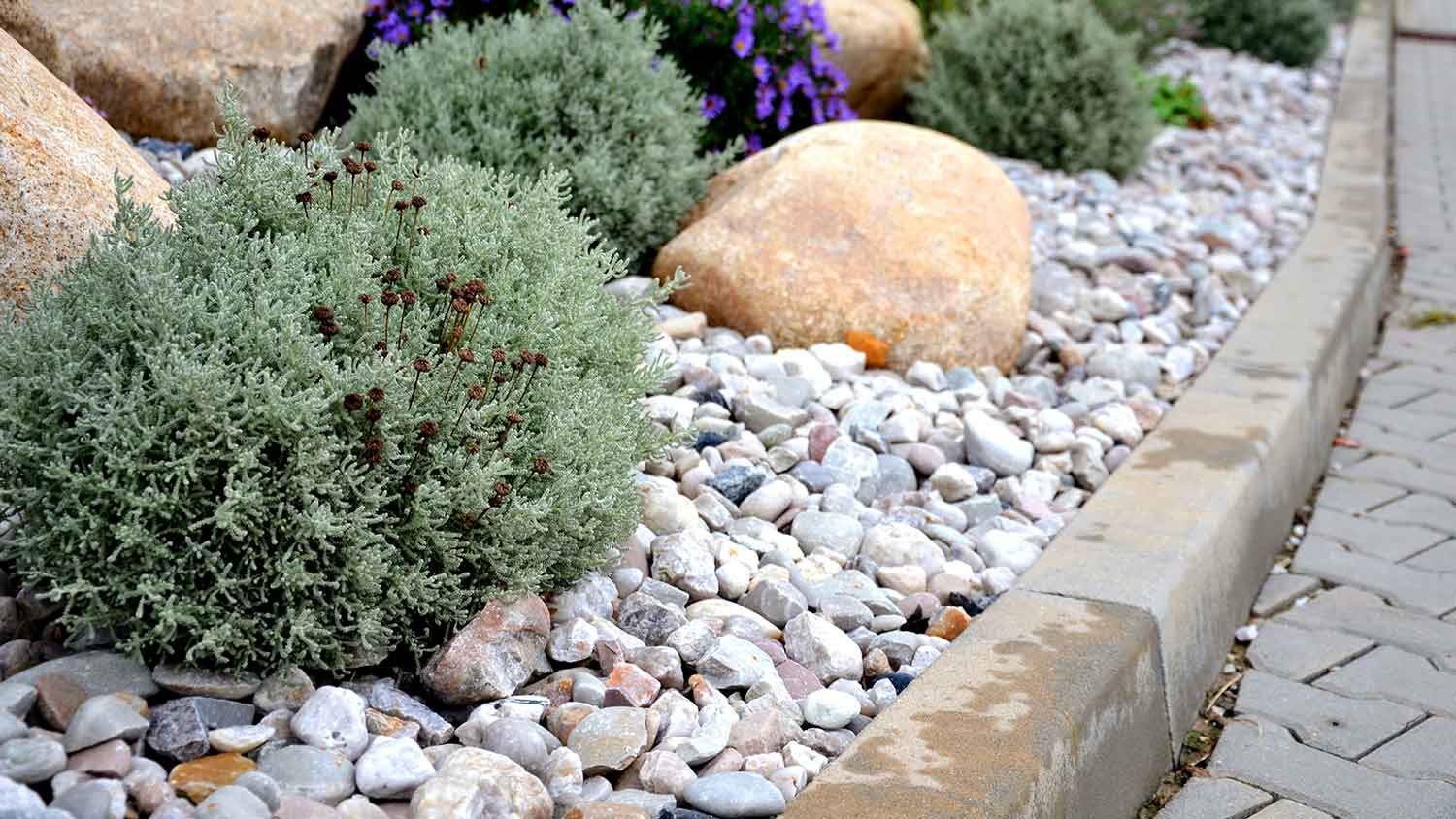 Large gravel size installed in a flowerbed