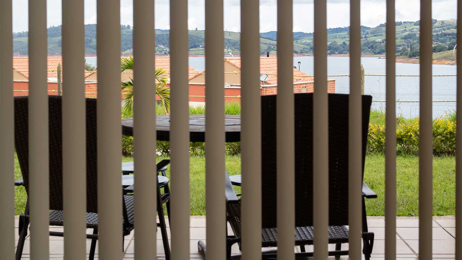 Lake view through vertical blinds