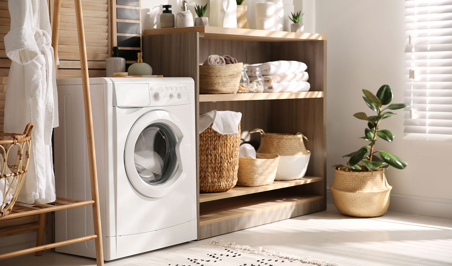 Laundry room with washing machine and shelving storage