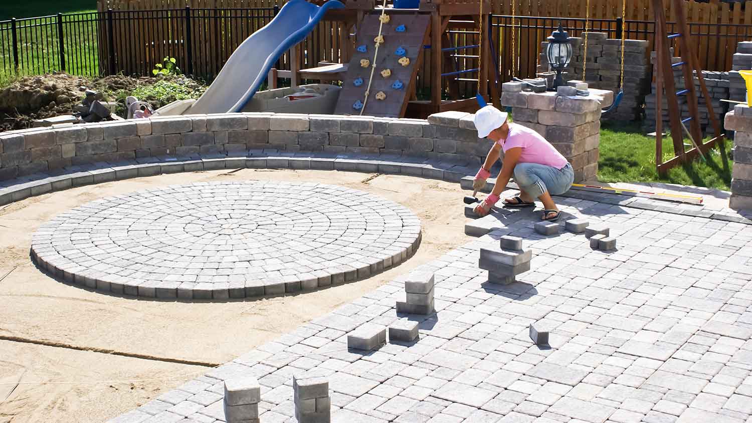 Designer laying new pavers on the patio