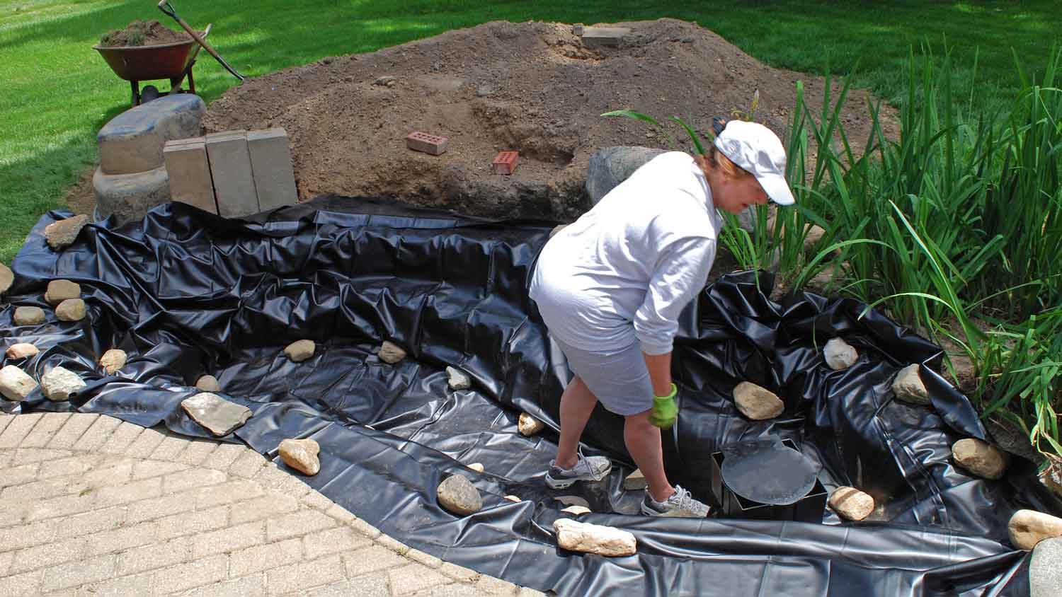 woman working on pond liner