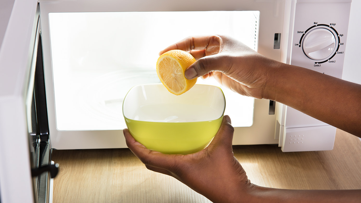 Sliced lemon in bowl going into microwave