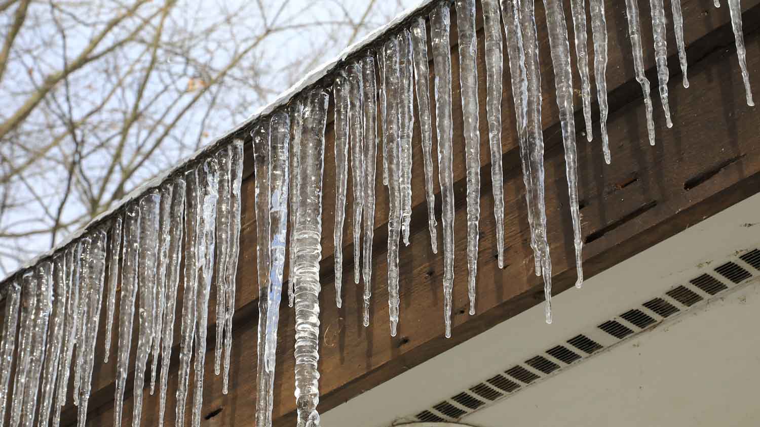 Line of icicles hanging from a house roof