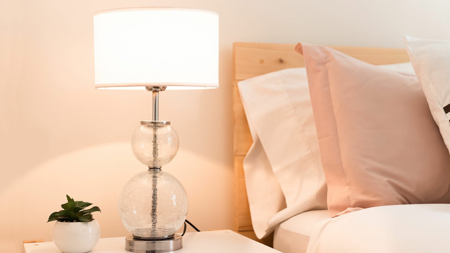 lit lamp on bedroom nightstand