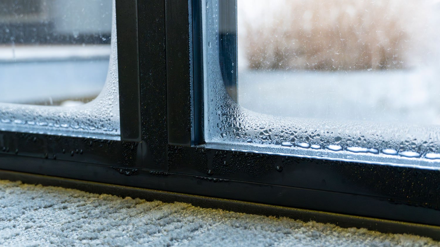 close up of double glazed window door condensation causes by excessive moisture in the house
