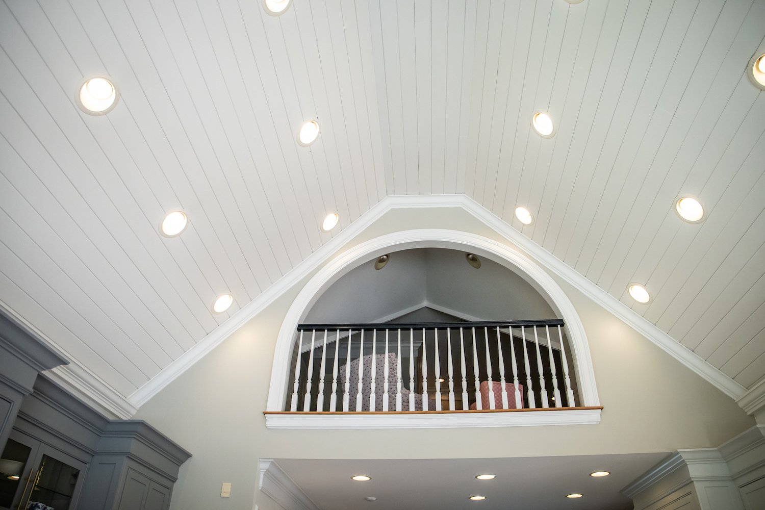 Shiplap cathedral ceiling with can lights and upper loft