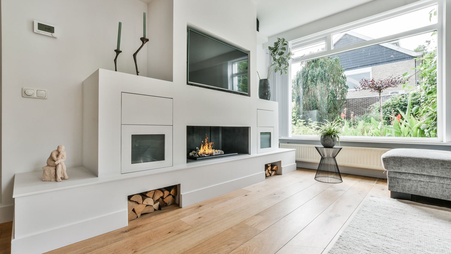 A living room with wooden floors and a fireplace