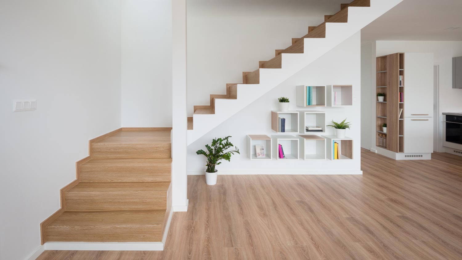 A living room with wooden stairway