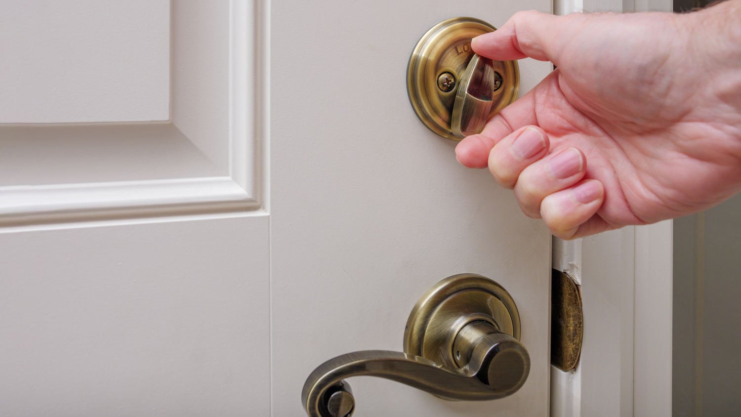man locking front door