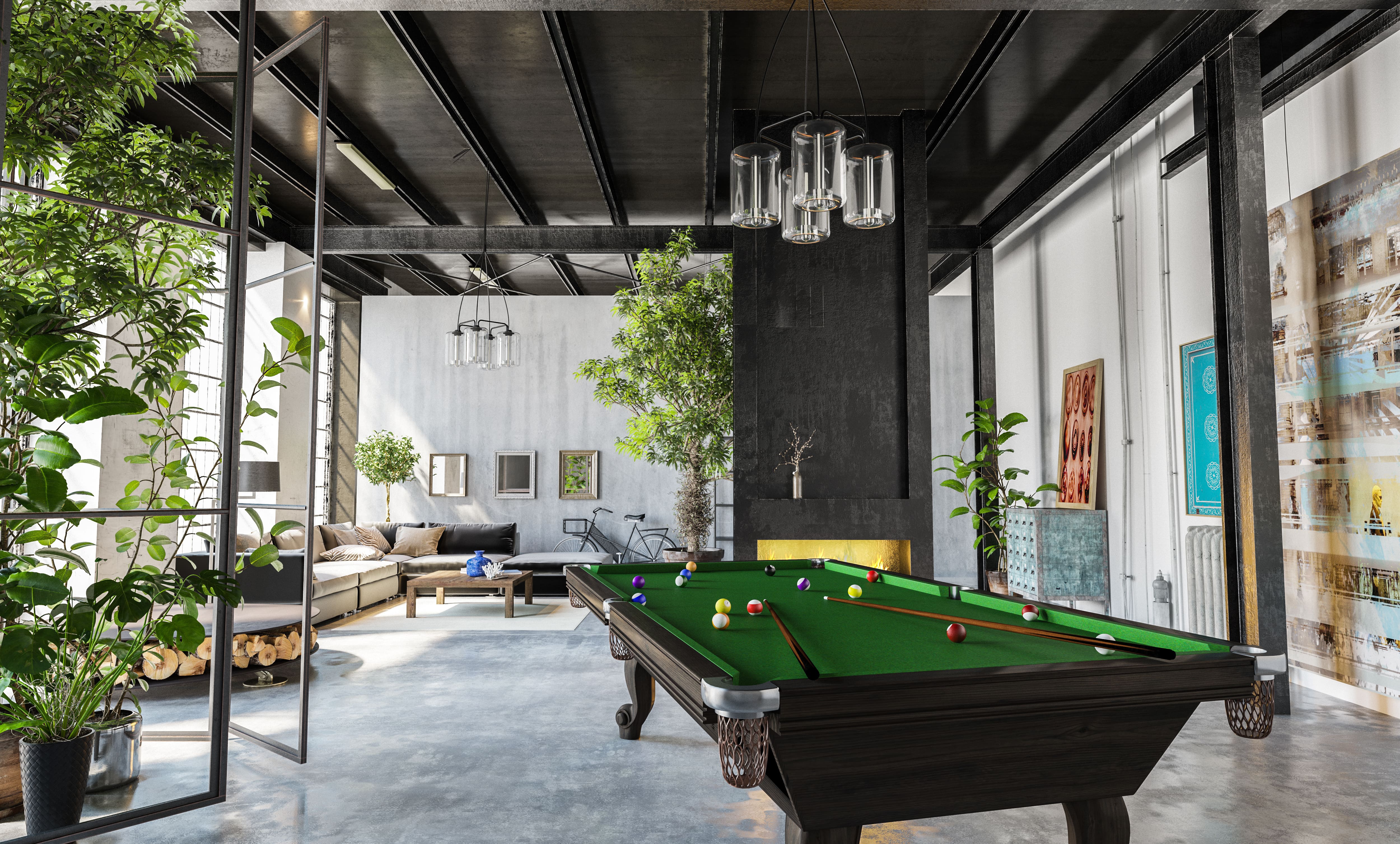 A loft apartment with a large pool table on one side