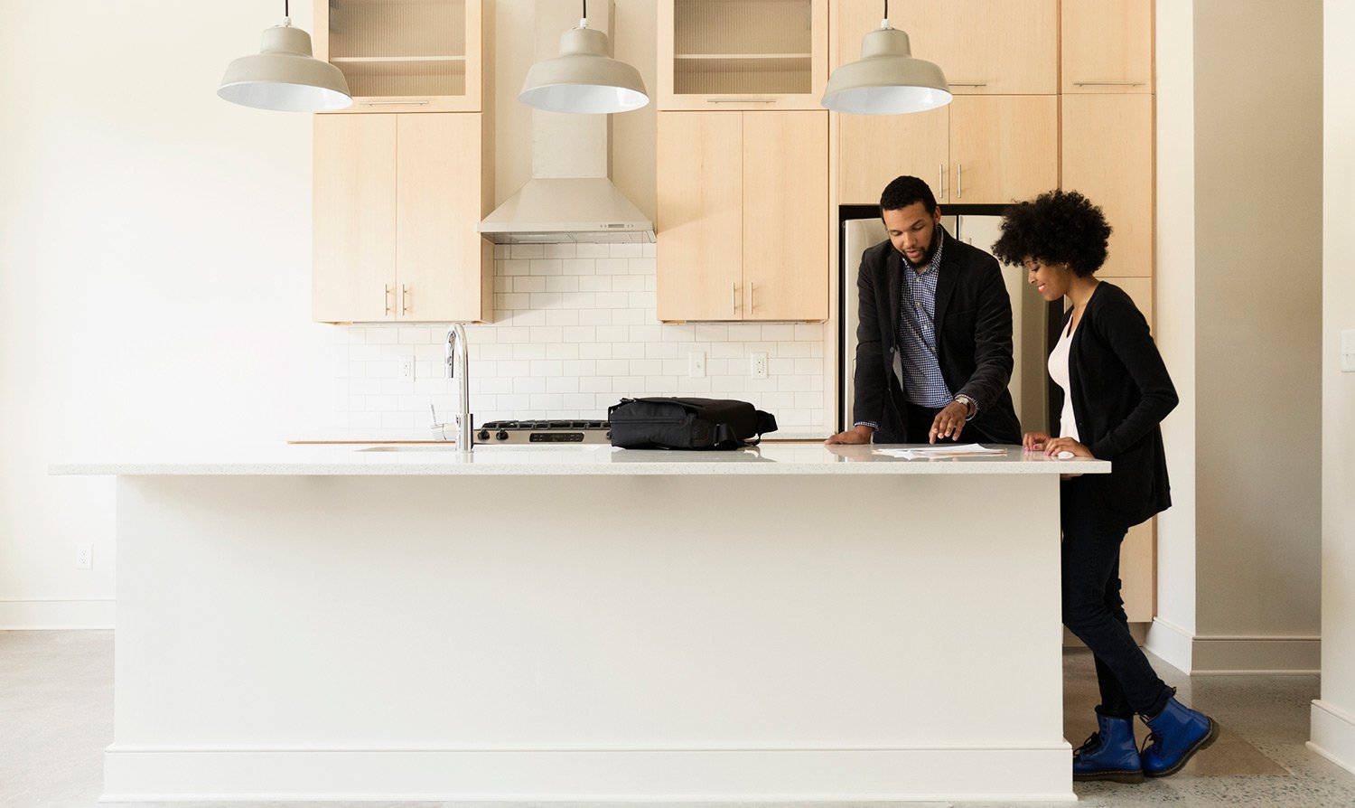 Man and woman look over paperwork in new house