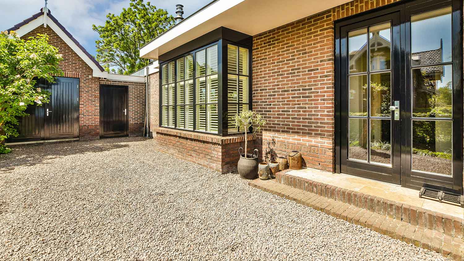 Brick house with loose gravel driveway