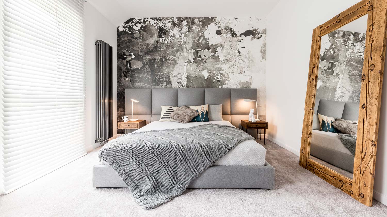 A luxurious and spacious bedroom with a grey carpet