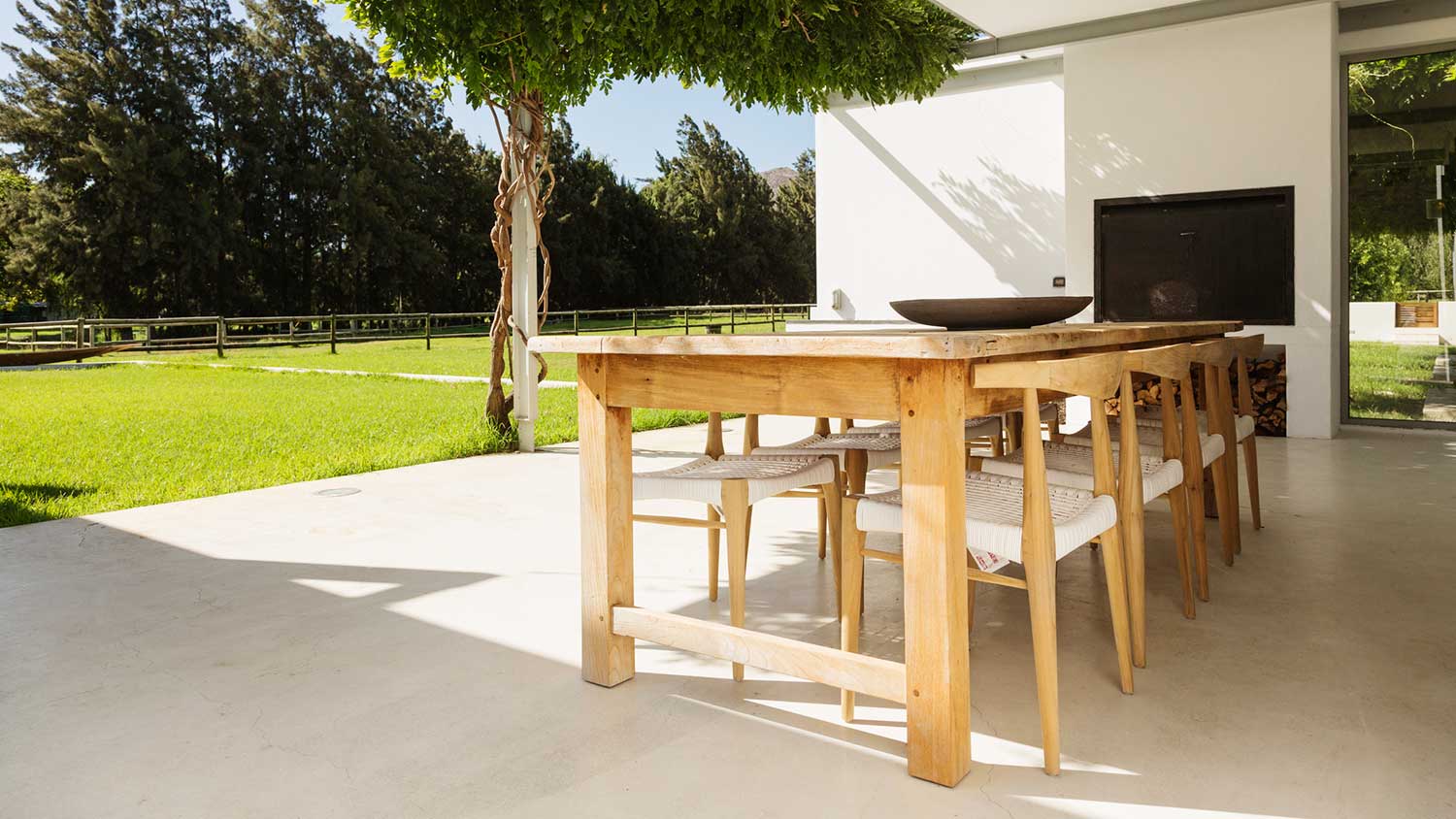 Wooden table and chairs on a luxury concrete patio