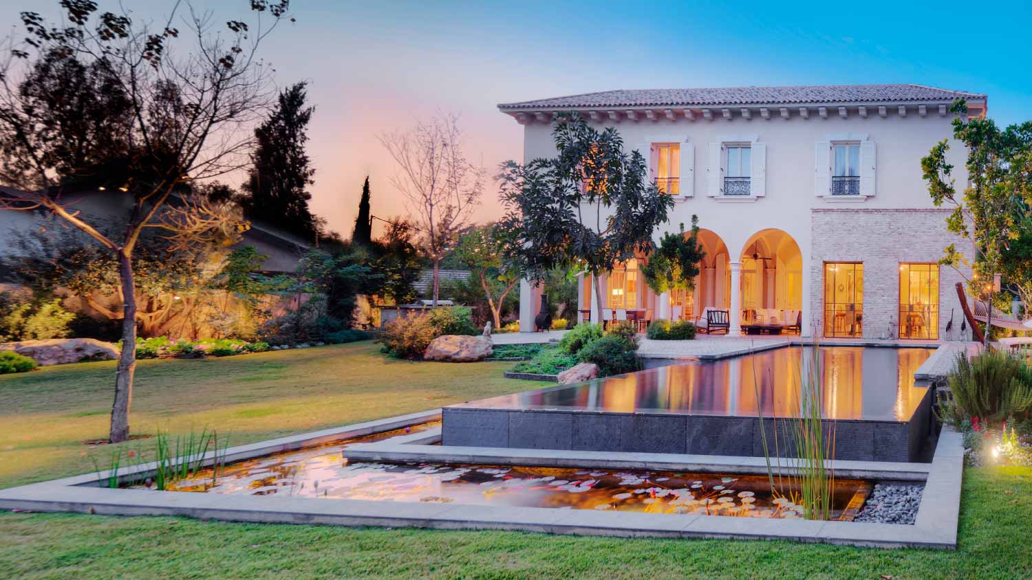 A luxury house with pool and pond