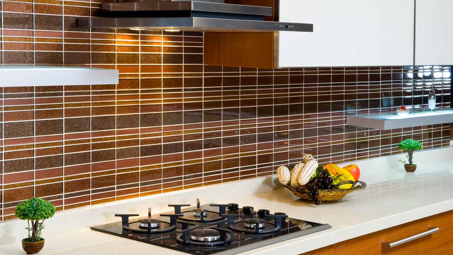 A luxury kitchen with glass tiles on the backsplash