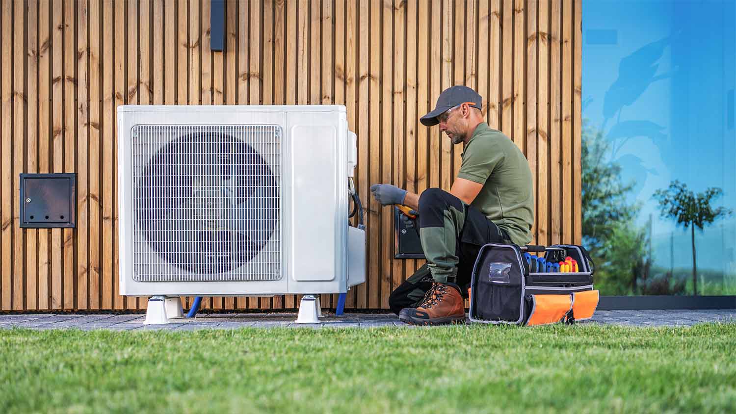 tech performing maintenance on mini split ac