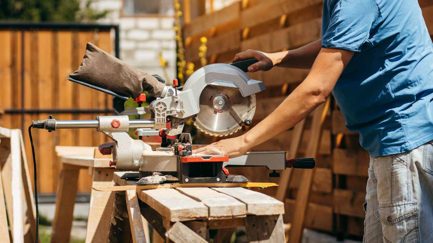 Man assembling a modern wooden fence