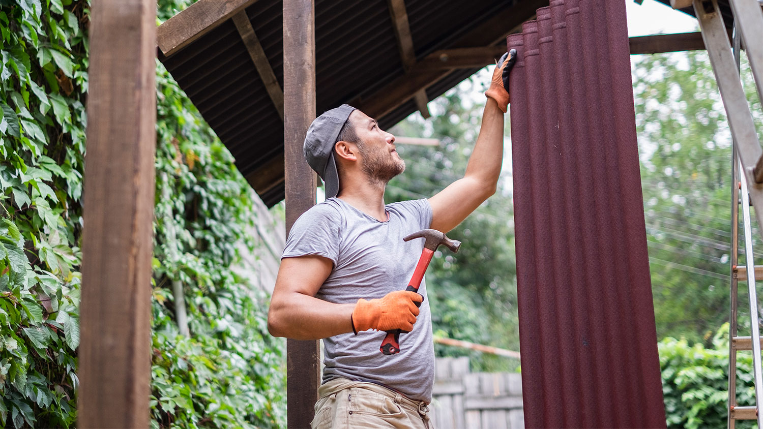 man building roof of cabana 