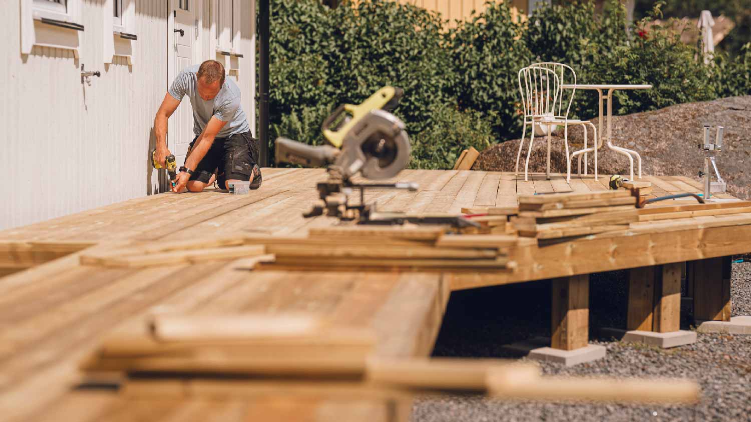 A man building a wooden deck