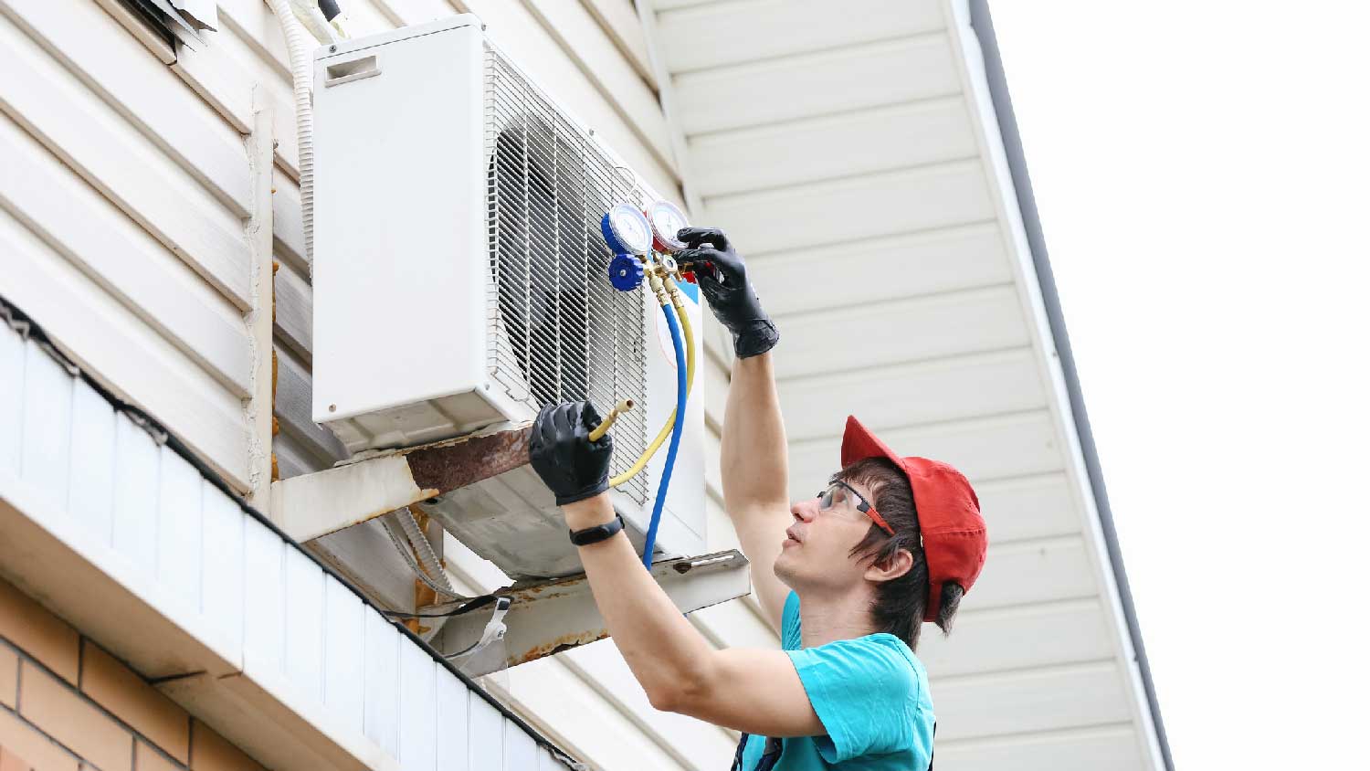 A man checking the refrigerant of a mini split AC 