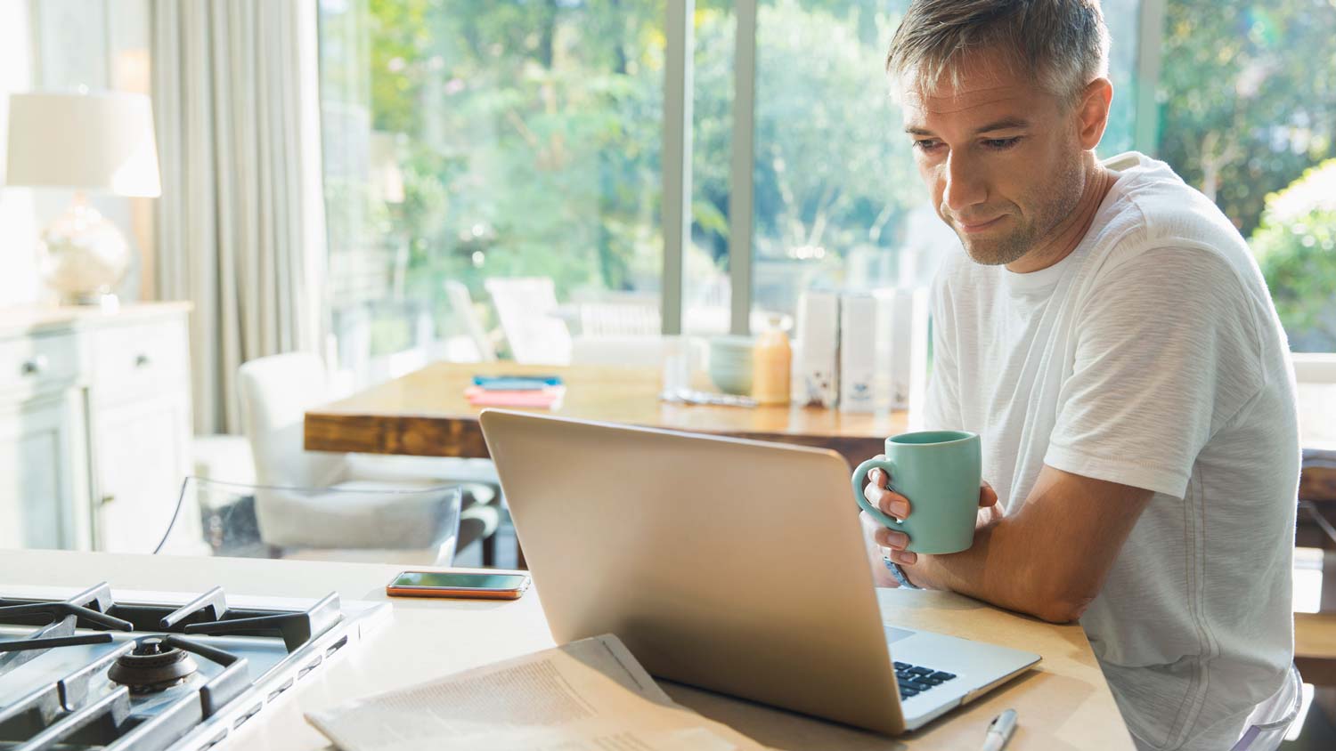 A man checking the refrigerator’s manual on his laptop