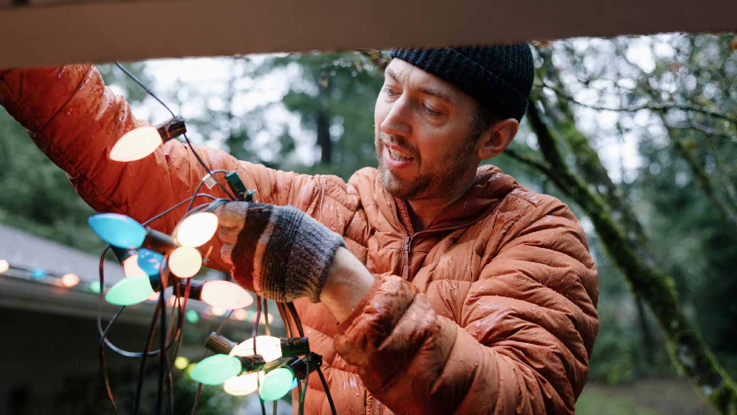 A man checking a strand of Christmas lights