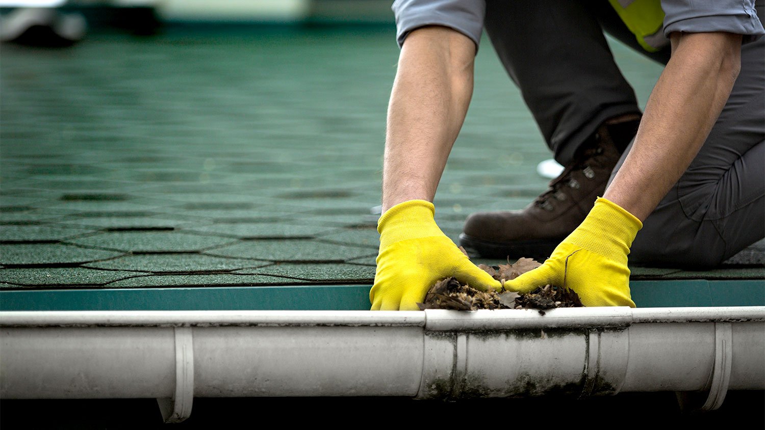 A man cleans gutters