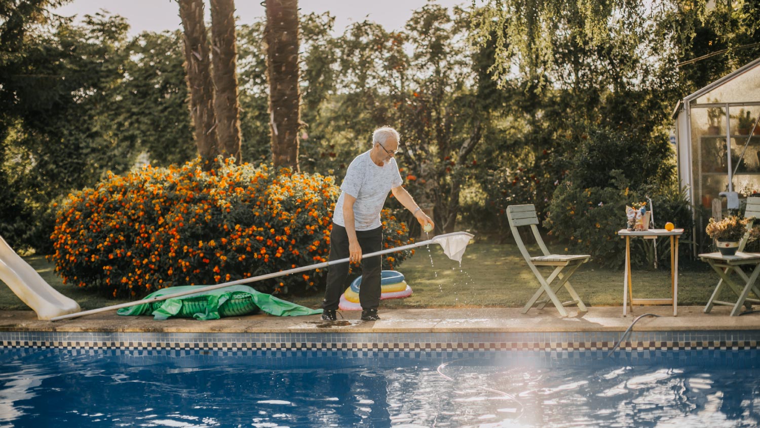 A man cleaning the pool