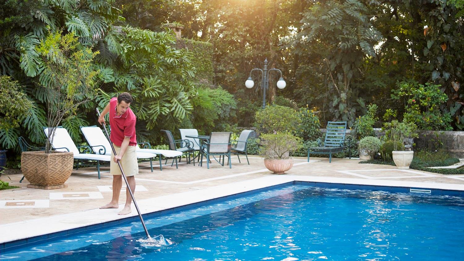 A man cleaning a swimming pool