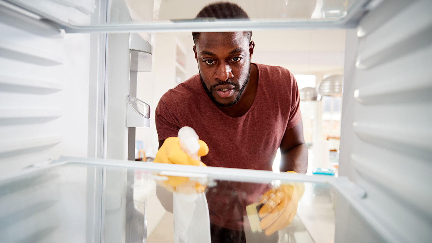 man cleaning out fridge