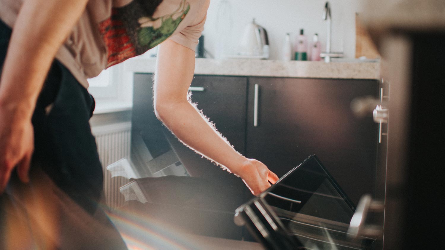 A man closing an oven door