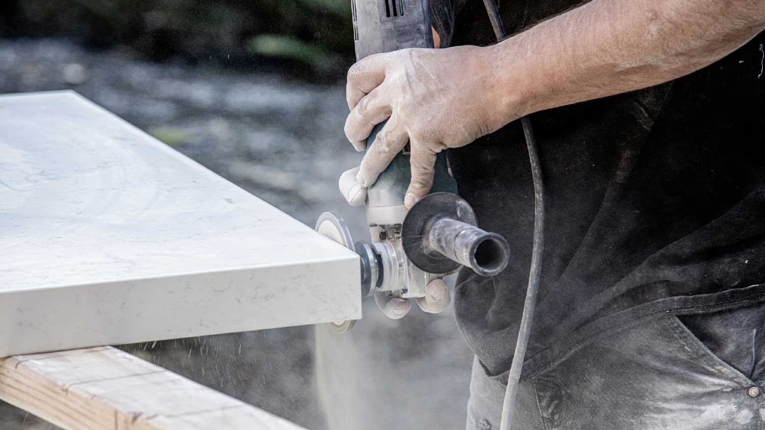 A man cutting a quartz countertop