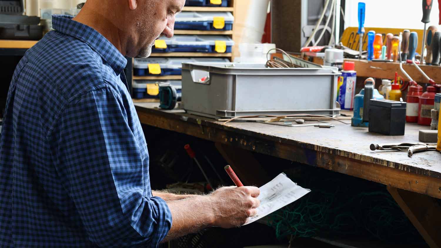 A man designing a shelving plan