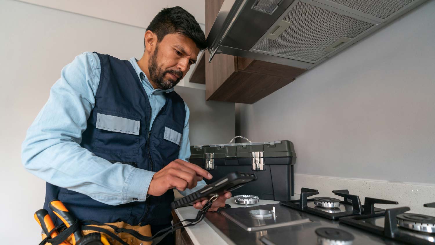 A man examining an oven