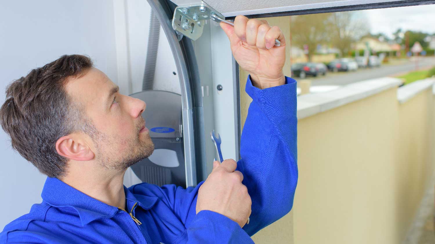 A man fixing garage door extension spring