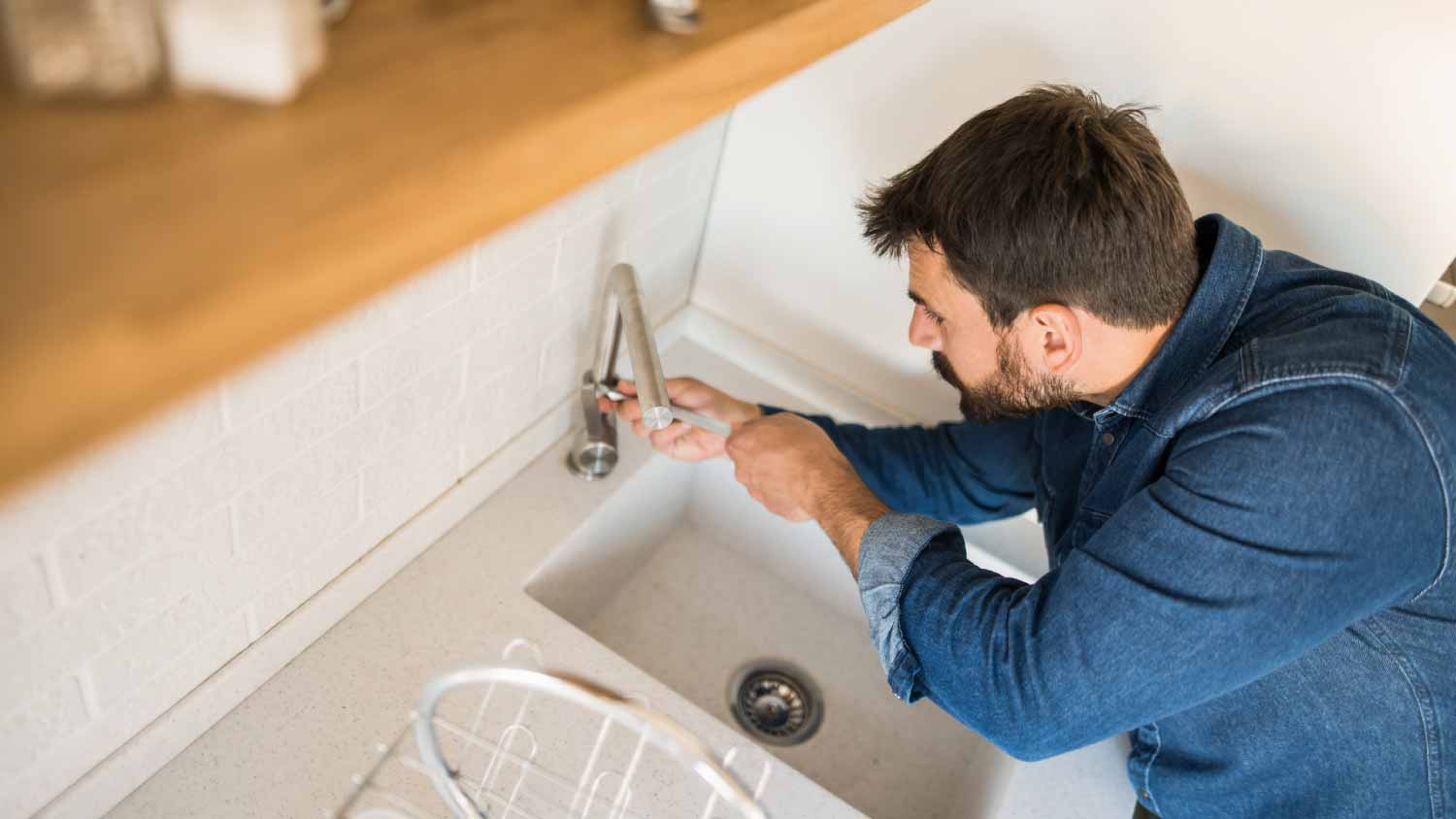 Man fixing a water tap