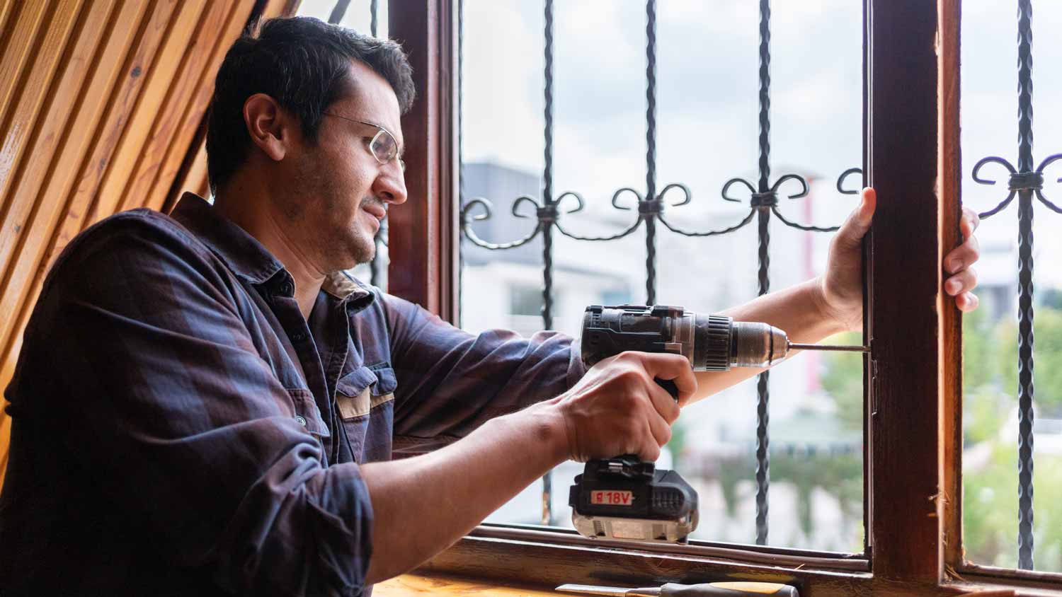 A man fixing a window crank