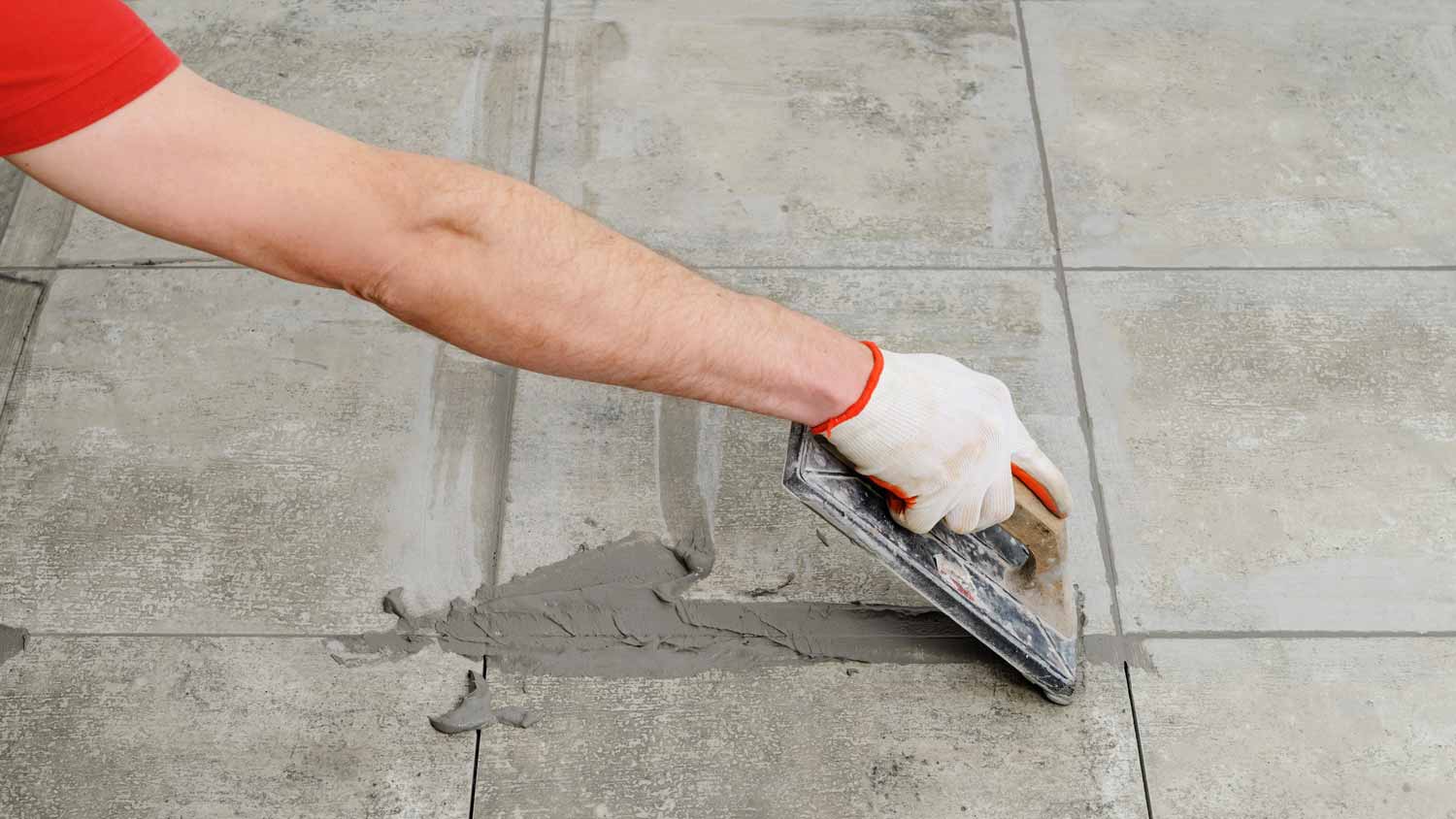 A man grouting ceramic tiles